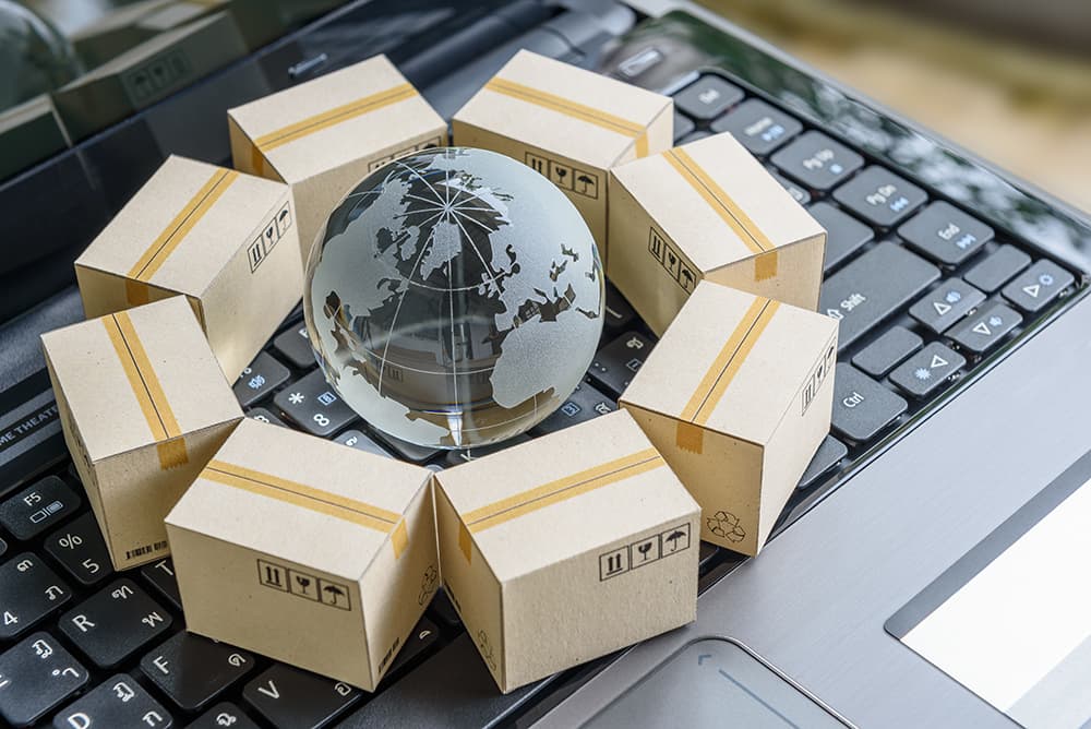 International packages surrounding a globe on a keyboard